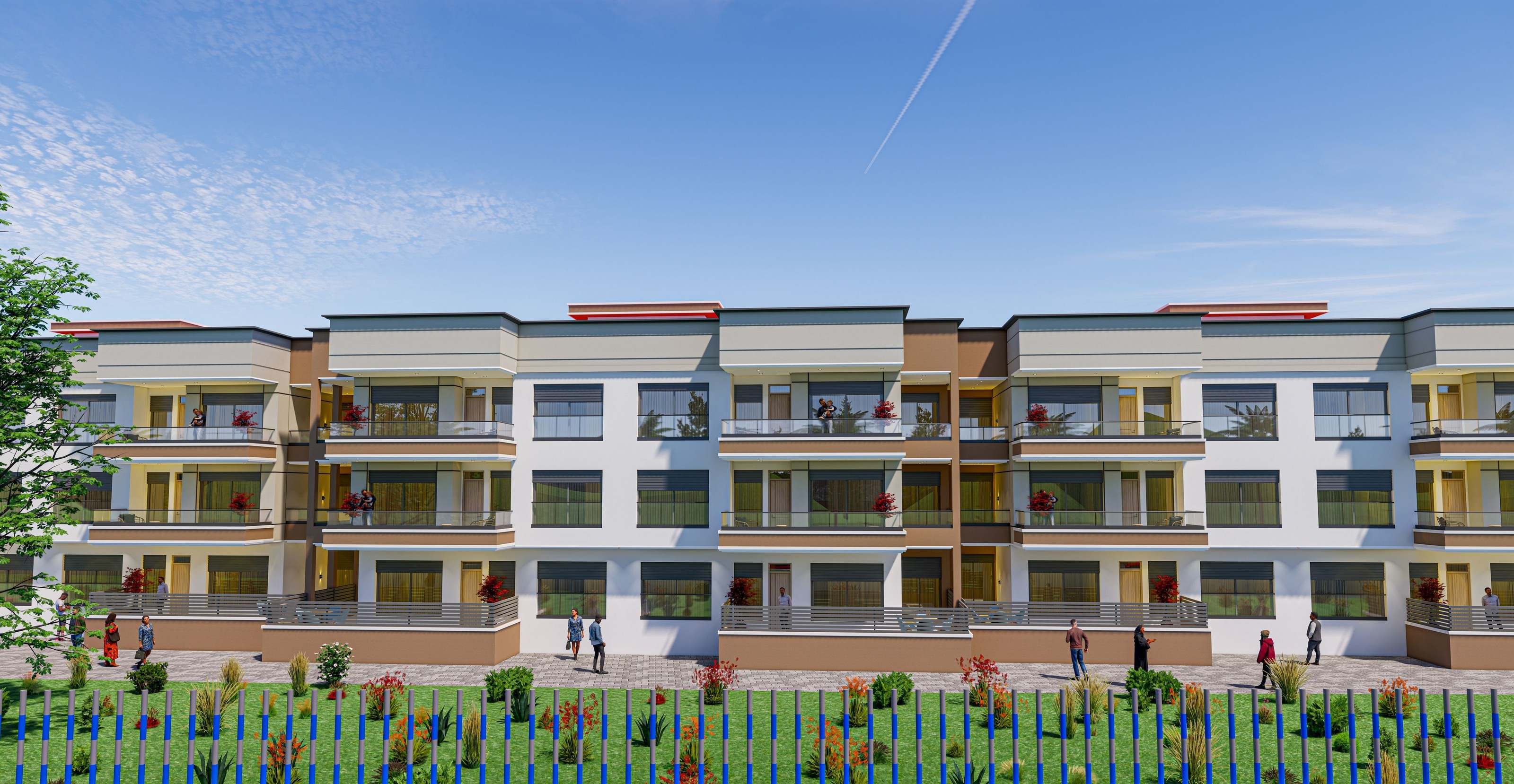 Les façades sable et blanc, derrière la clôture et la pelouse fleurie.